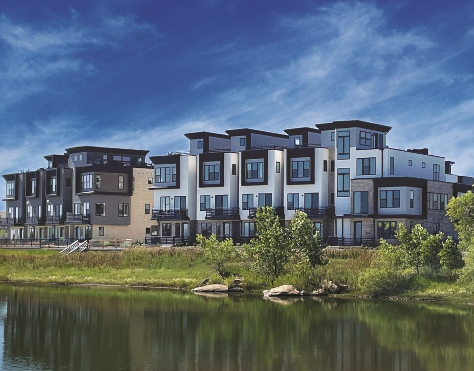 Modern buildings on the northwest side of Montmere, reflecting in a nearby pond.