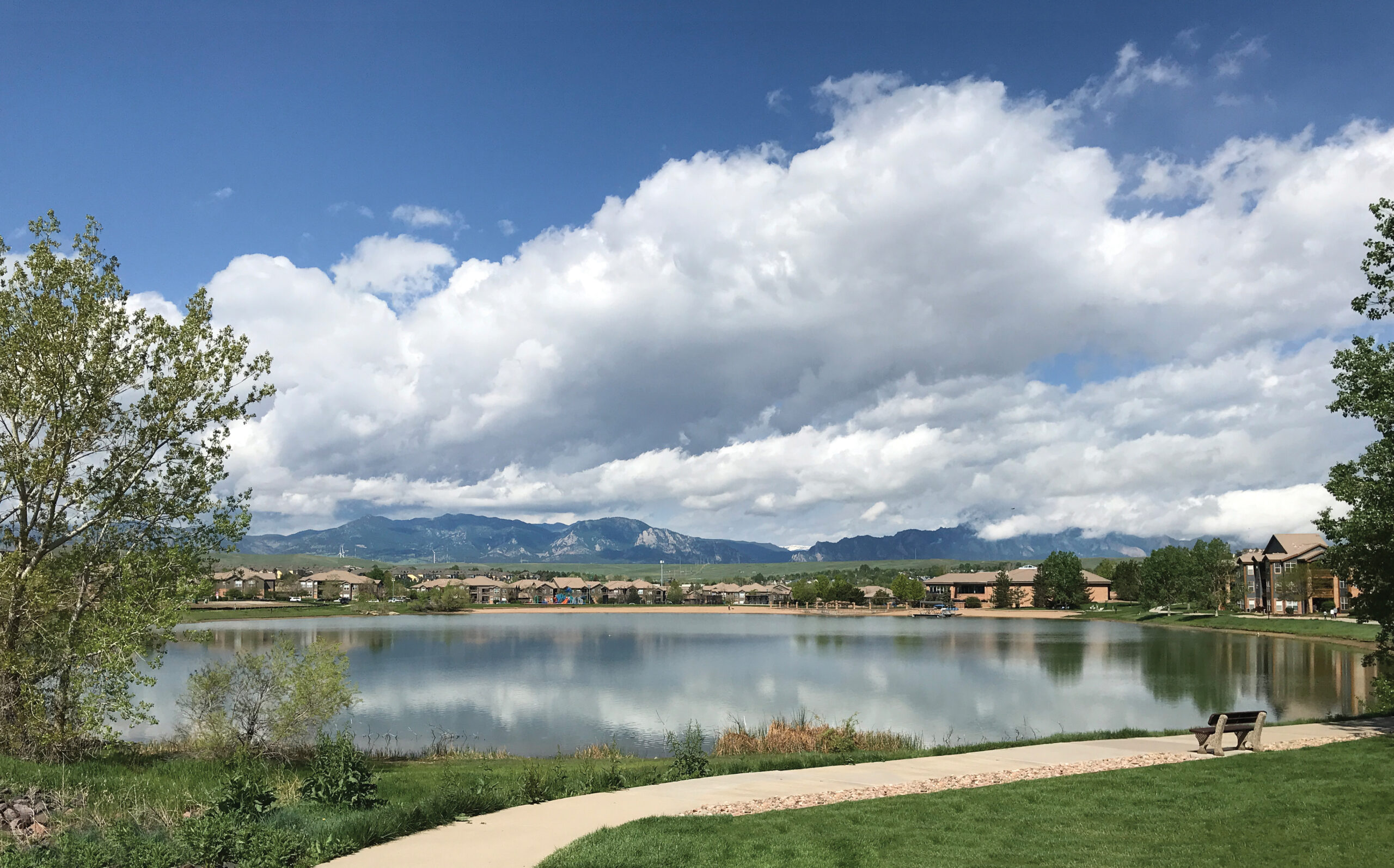 A serene view of Autrey Reservoir with mountains and a cloudy sky in the background